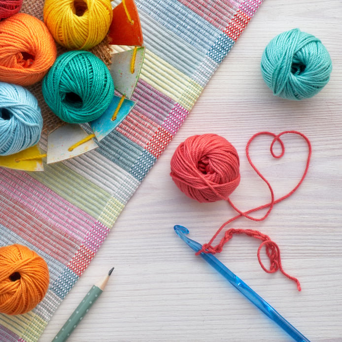 Colorful Yarn Balls, Knitting Supplies and Pencil on Wooden Background